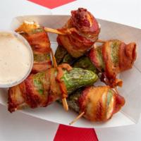 Jalapeño Poppers · Large jalapenos stuffed with cream cheese, and wrapped in bacon served with our own habanero...