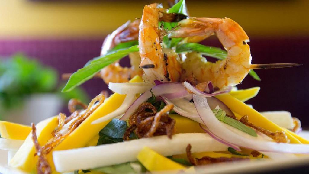 Sweet Mango Salad · Ripe mango slices with grilled shrimp, jicama, red onion, and basil, tossed in tangy lime vinaigrette topped with fried shallots.
