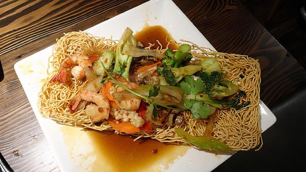 Seafood Bird'S Nest · Stir-fried tiger prawns, calamari, mushrooms and garden vegetables tossed in rice wine and oyster sauce, served on a nest of crispy eggs noodles.