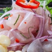 Ceviche De Pescado · Fresh fish of the day marinated with lemon juice and Peruvian spices, served with sweet pota...