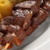 Anticucho De Corazon · Grilled beef heart skewers marinated with panca sauce, served with golden potatoes.