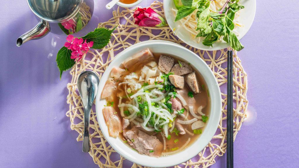 P-30.) Special Combination / Pho Dac Biet · Beef noodle soup with sliced rare beef, well-done brisket, vietnamese. Beef meatballs tendon and tripe. (pho tai, chin, bo vien, gan, sach)
