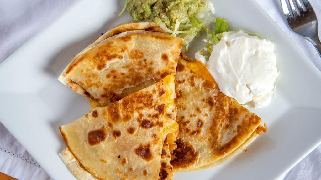 Cheese Quesadilla · A 12’’ flour tortilla stuffed with cheddar & Jack cheese, grilled to a golden crisp and served with sour cream & fresh made guacamole.