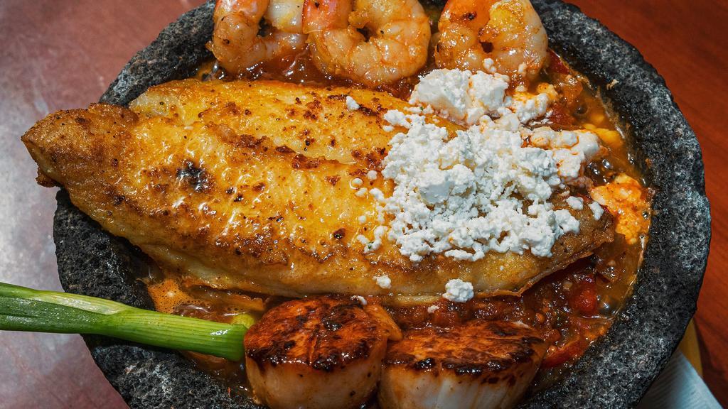 Molcajete Mariscos · Delicious plump scallops, grilled jumbo shrimp and a fillet of Tilapia fish simmered in our famous molcajete sauce with chopped fajitas veggies, onions and a squeeze of fresh lemon.
