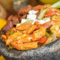 Molcajete Ultimo · Delicious plump scallops, grilled jumbo shrimp, and a filet of Tilapia fish simmered in our ...