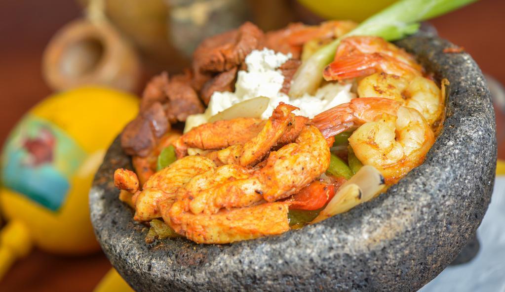 Molcajete Ultimo · Delicious plump scallops, grilled jumbo shrimp, and a filet of Tilapia fish simmered in our famous molcajete sauce with chopped fajita veggies, onions, and a squeeze of fresh lemon.