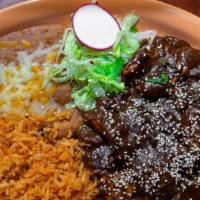 Pollo En Mole · A classic dish from Puebla served Guadalajara style! Our home made recipe consists of chiles...