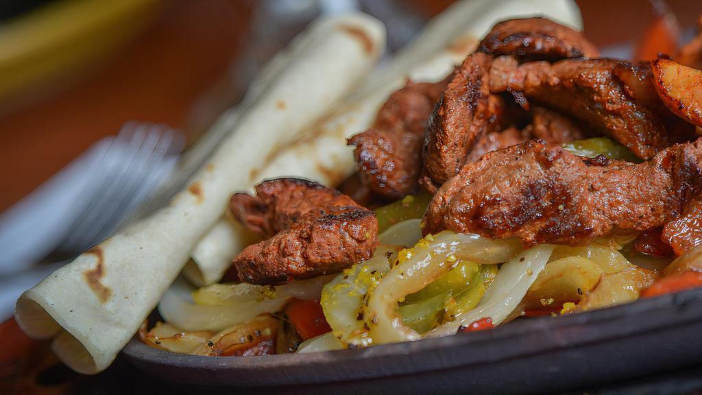 Grilled Steak Fajitas · An 8 oz portion of grilled top quality beef, marinated in Mexican spices and served over fajita veggies.