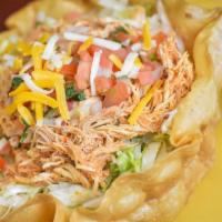 Taco Salad · A fried 12’’ flour tortilla shell filled with refried beans, lettuce, cheese, and your choic...