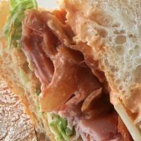 Scorched Pig Sandwich · Ciabatta, Scorch Sauce, Ham, Caramelized Onions, Tomato Jam, Bacon, Provolone, & Lettuce