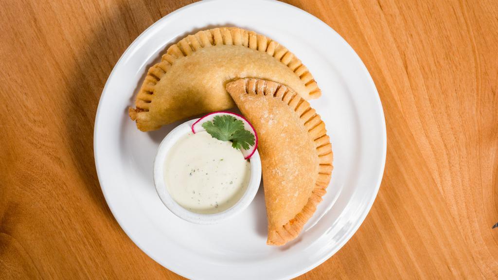Empanadas  · House made and filled with slow cooked pork & beef with melty cheese