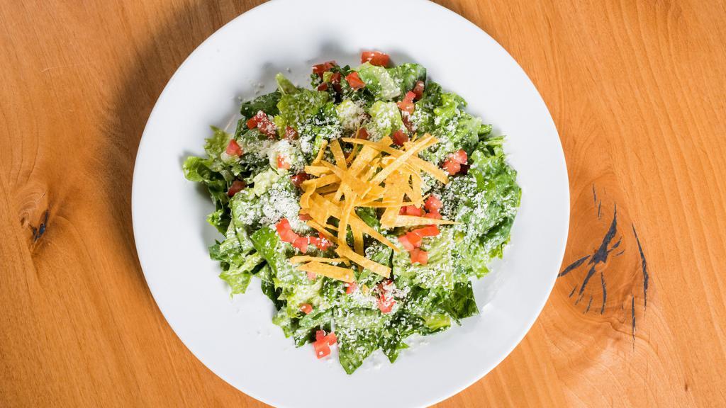 Small Caesar · Romaine tossed with a garlicky anchovy dressing, cotija cheese, and tortilla strips.