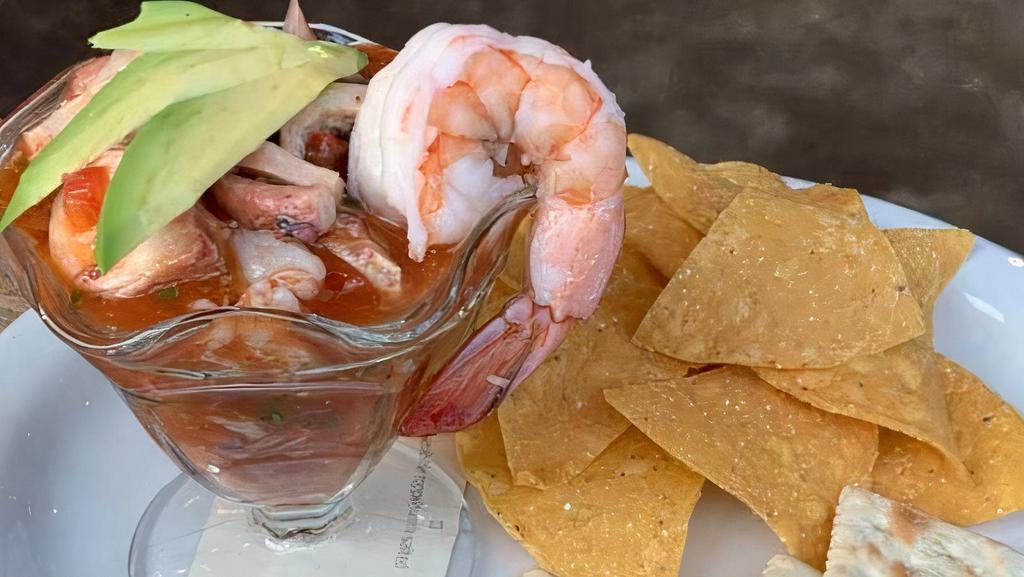Coctel De Mariscos · Del Pacifico wild shrimp and tender Spanish octopus,  in a spicy cocktail sauce, served with tostadas and saltines.