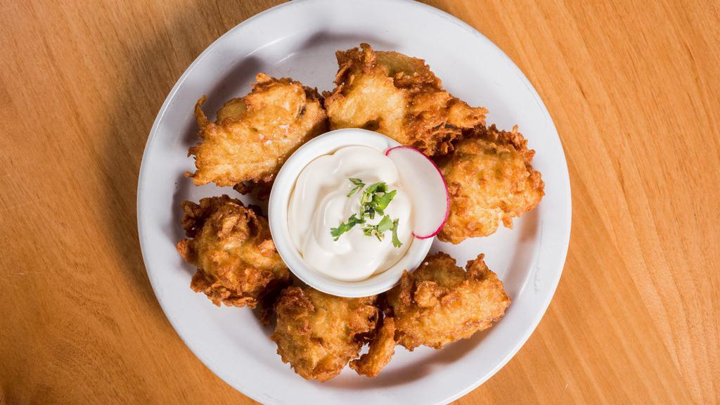Yucca Root Fritters · Shredded yucca root, masa, and egg dough, fried crispy, and served with Don Froylan Mexican crema.