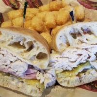 Kyle'S Sandwich · On a ciabatta roll with garlic butter, Caesar dressing, turkey, ham, dill pickle chips and S...