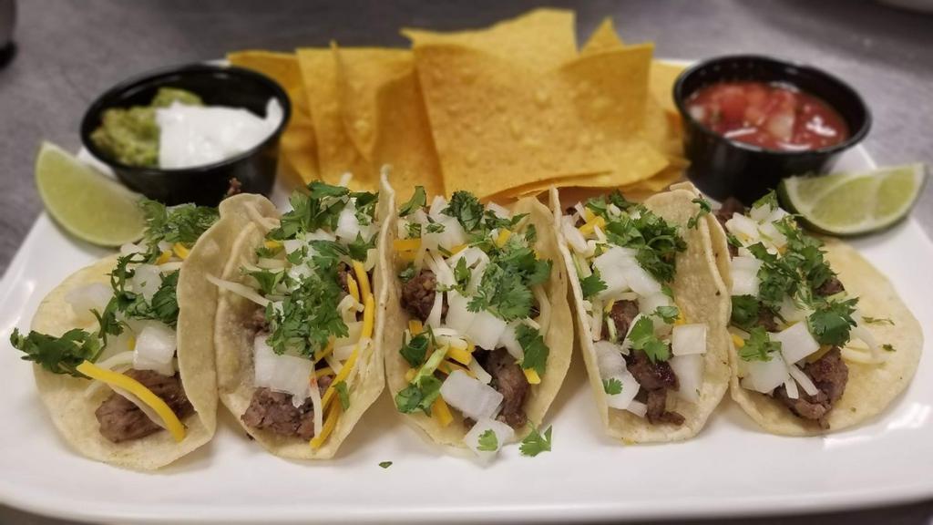 Street Tacos · Classic food truck faire. Tender steak served with cheddar & pepper Jack cheese, onions and cilantro. Served on corn tortillas with fresh lime for squeezin’, sour cream, HopsnDrops housemade salsa and guacamole.