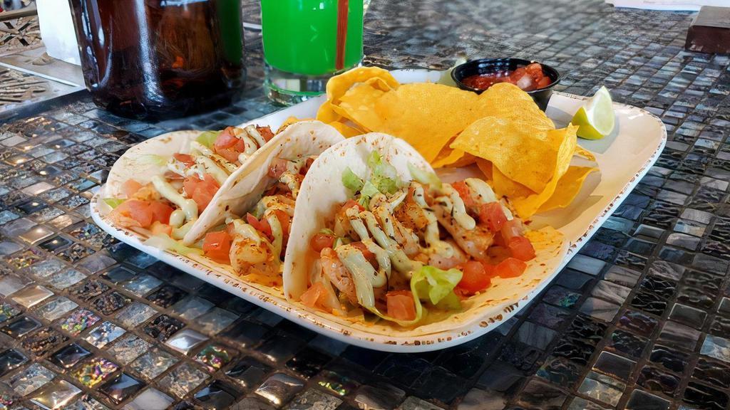 Cajun Shrimp Tacos · Grilled Cajun shrimp with chipotle mayo, shredded lettuce, dice tomatoes, drizzled with avocado ranch on flour tortillas. Served with tortilla chips, fresh house made salsa and lime.