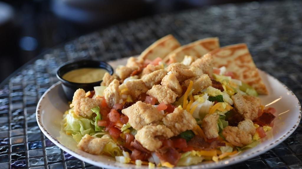 Chicken Tender Salad · Mixed greens with hand breaded chicken fingers, diced egg, tomatoes, shredded cheddar and bacon. Served with honey mustard dressing on the side. Kick it up a notch and try it buffalo style!