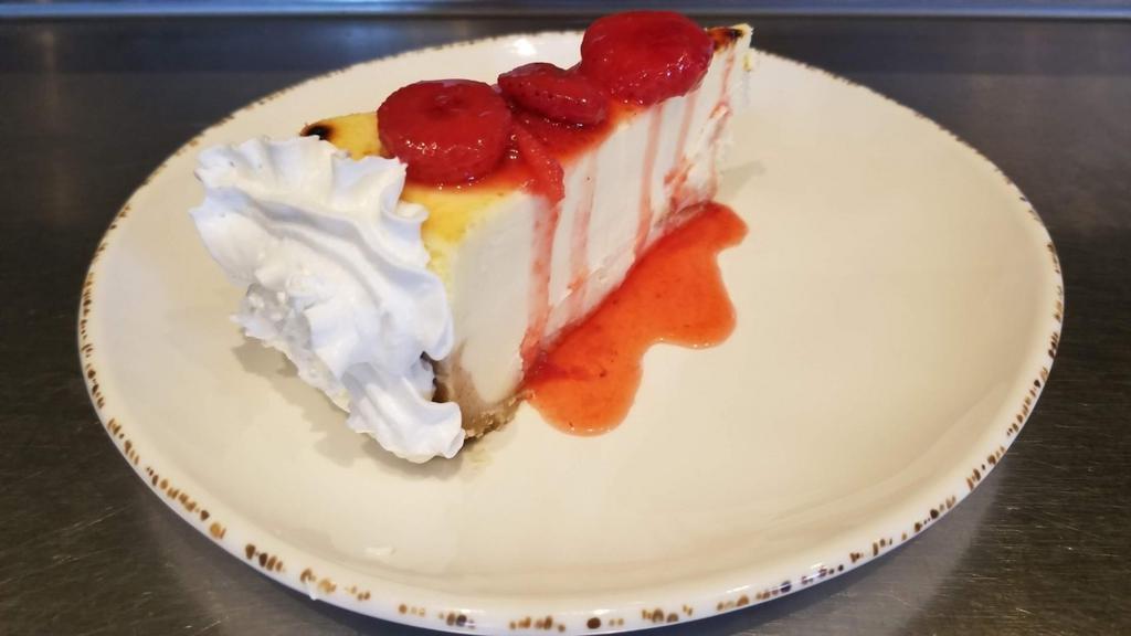 Creamy Ny Style Cheesecake With Fruit · Creamy New York style cheesecake atop a graham cracker crust. Choose your topping of strawberries, raspberries, mangos, peaches, blueberries or huckleberries.