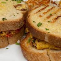 Breakfast Panini · Scrambled eggs, avocado, roasted red pepper, cheddar cheese, bacon, fruit or hash browns.