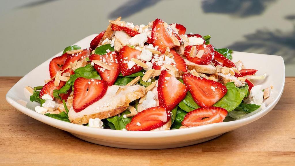 Strawberry Salad · Grilled & chilled chicken breast, baby spinach, feta cheese, slivered almonds & fresh strawberries. Served with a side of strawberry dressing.