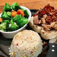 Pulled Pork Plate Lunch · Slow-smoked, hand-pulled, and lightly sauced with your choice of sauce and served over garli...