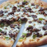 Philly Cheesesteak Pizza · Shaved steak, green and red peppers, onions, mushrooms and secret savory sauce.