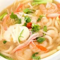 Seafood Udon Soup · Japanese Udon noodle soup cooked with scallop, shrimp, crab stick, fish cake, poached egg an...