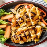 Japanese Teriyaki · Your choice of grilled meat is served sizzling hot on a bed of caramelized sweet onions dren...