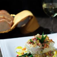 Halibut Javier · Pan seared Alaskan halibut topped with a mango, pineapple, onion, cilantro salsa, and pineap...