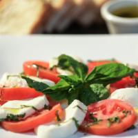 Caprese · Tomato, basil, fresh mozzarella, a drizzle of extra virgin olive oil, sea salt, and pepper.