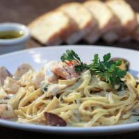 Fettucine Di Mare · Shrimp, fresh seafood, clams, and scallops with a choice of parmesan cream sauce or spicy re...