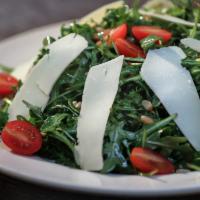 Arugula Salad · Baby arugula, grape tomatoes, pine nuts, and parmesan with an extra virgin olive oil and lem...