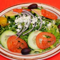 Traditional Salad · Lettuce topped with tomato, cucumber, onion, and feta cheese with tzatziki sauce.