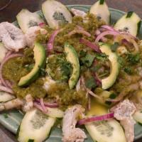 Tostada De Aguachile · Fresh shrimp marinated in lime juice, thinly sliced onion and cucumber