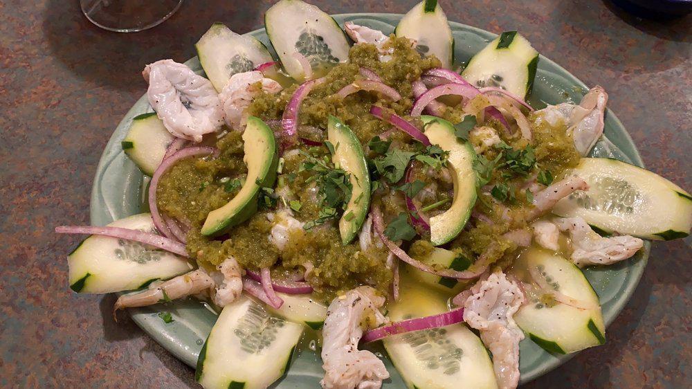 Tostada De Aguachile · Fresh shrimp marinated in lime juice, thinly sliced onion and cucumber