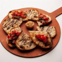Bruschetta · Grilled peasant bread with roma tomatoes, basil, garlic, balsamic vinegar and olive oil.