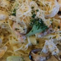 Seafood Fettuccine · Shrimp, clams, scallops, salmon, cod and Dungeness crab in a garlic cream sauce with onions,...