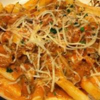 Penne Salsiccia · Sausage, mushrooms and roasted garlic in a rosemary-tomato cream sauce.