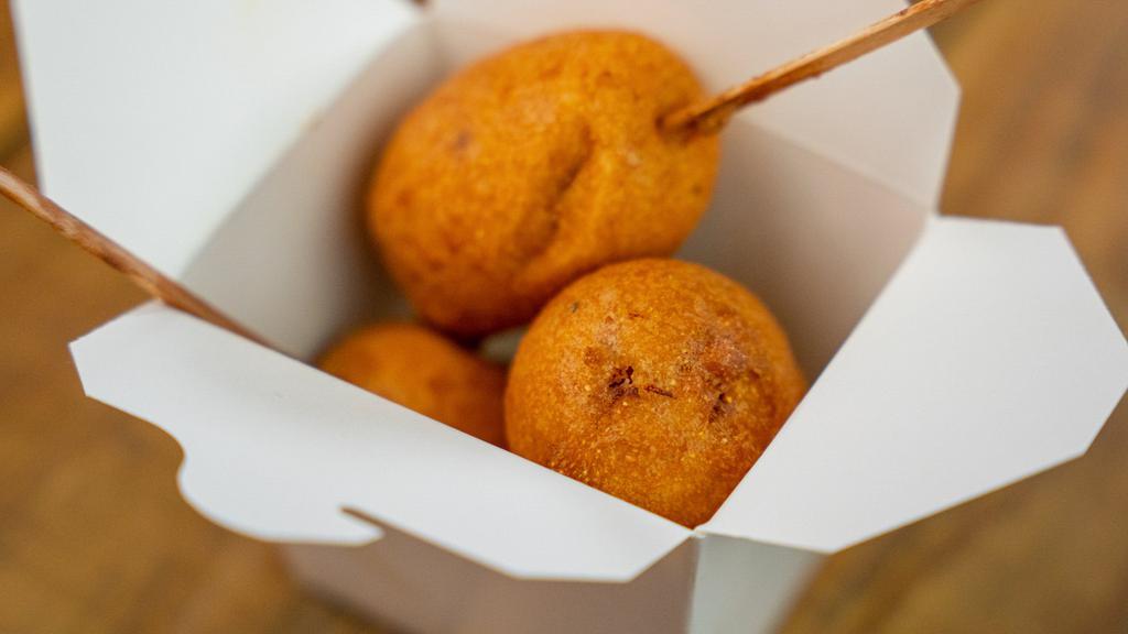 Corn Puppies · Three all-beef corn dogs served with curry ketchup and yellow mustard.