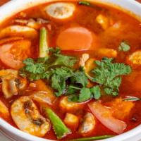 Tom-Yum Soup · Spicy and sour lemongrass soup with thai herbs, kaffir leaves, tomato, mushroom.