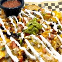 Nachos · Montery Jack and Cheddar cheese, black beans, layered on house made tortilla chips, topped w...