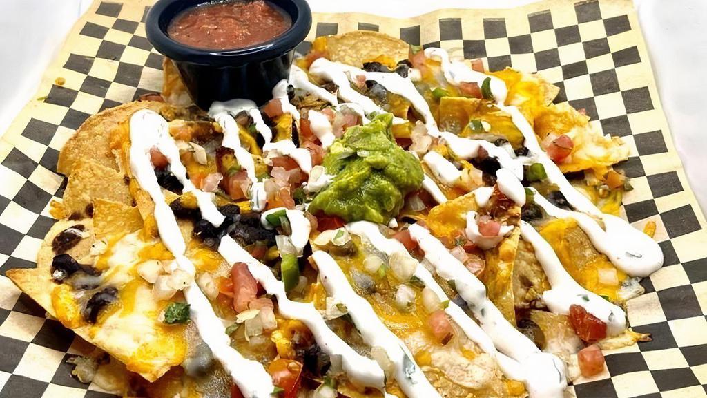Nachos · Montery Jack and Cheddar cheese, black beans, layered on house made tortilla chips, topped with cilantro lime sour cream, guacamole, and pico de gallo. Add grilled chicken, house smoked pulled pork, or tempeh for $5