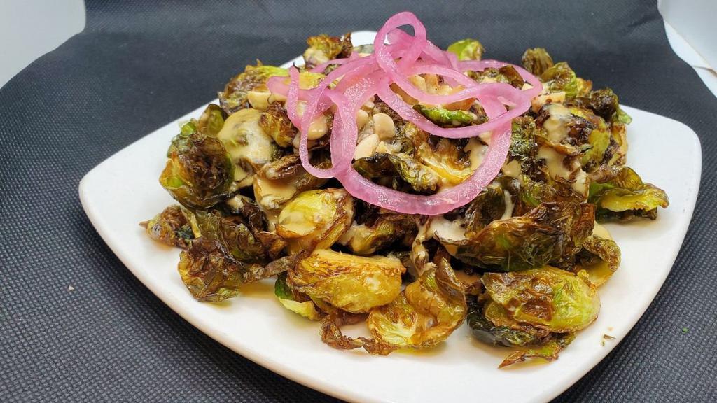 Brussels Sprouts · Flashed Fried, Garlic Miso Sauce, hazelnuts, Pickled onions. (Vegan)