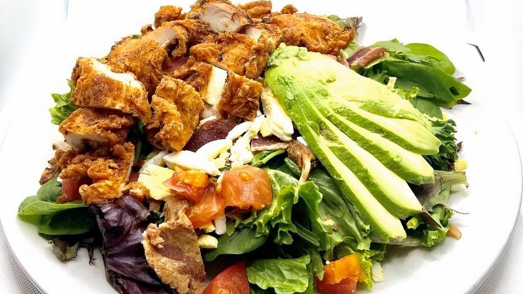 Crispy Chicken Salad · Crispy chicken, avocado, chopped hard boiled egg, bacon bits, diced tomato all on a bed of mixed greens.