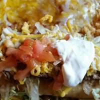 Enchilada · A soft corn tortilla with your choice of filling. And onion, rolled then covered with our sp...