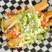 Rolled Tacos (9) · Shredded beef rolled tacos, deep fried, and topped with cheese, lettuce, pico de gallo, and ...
