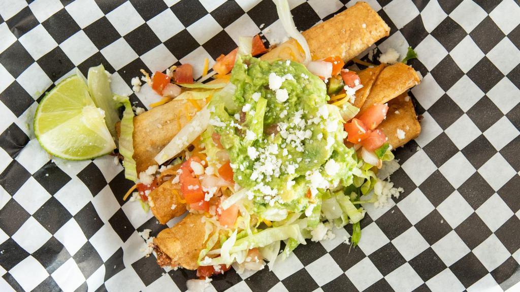 Rolled Tacos (5) · Shredded beef rolled tacos, deep fried, and topped with cheese, lettuce, pico de gallo, and guac.