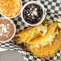 Taco Plate · 3 crispy corn taco shells filled with stewed red chicken or shredded beef. Topped with lettu...