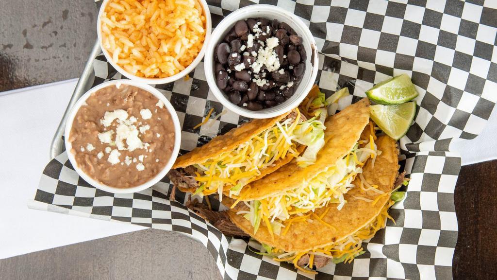 Taco Plate · 3 crispy corn taco shells filled with stewed red chicken or shredded beef. Topped with lettuce or cabbage slaw and cheese.
